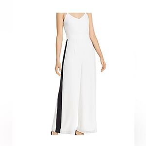Aqua brand white flare leg jumpsuit with black stripes on both sides